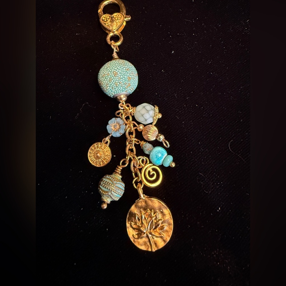 Gold and Turquoise colored bag charm hangs 3 3/4 inches